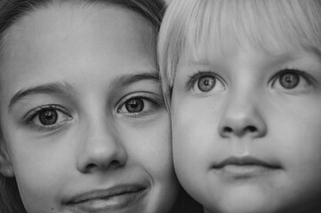 Monochrome photo of two sisters. Close-up portrait of girls.