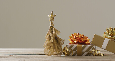 Image of christmas gifts with christmas tree decoration on wooden background