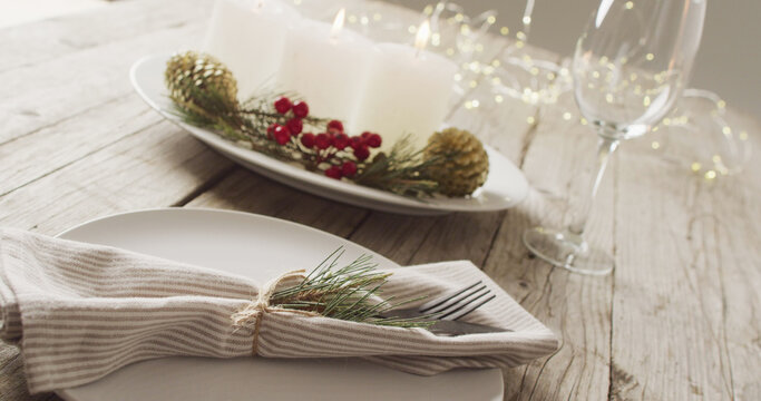 Image of christmas place setting with cutlery and candles on grey background