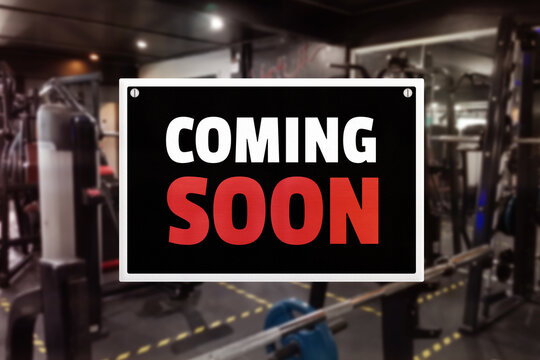 A coming soon sign at a gym. Promotion of upcoming fitness center.