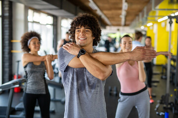 Fototapeta na wymiar Fitness, sport, people and lifestyle concept. Group of smiling people exercising together in gym