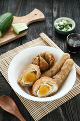 Pempek, Empek-Empek, traditional food from South Sumatra, Indonesia. This fish-based food is very popular. Served with cuko sauce and cucumber slices.
