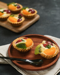 Delicious mini pie with fresh fruits, close up
