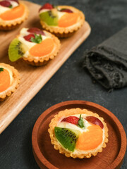 Delicious mini pie with fresh fruits, close up
