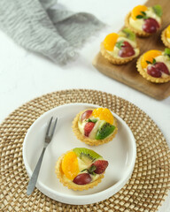 Delicious mini pie with fresh fruits, close up
