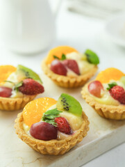 Delicious mini pie with fresh fruits, close up

