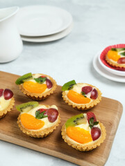 Delicious mini pie with fresh fruits, close up
