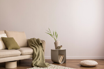 Interior design of living room with copy space, beige sofa, side table, leaf in vase, pouf, elegant...