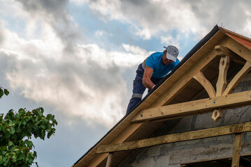 Roofer man roof carpenter working Country house renovation.