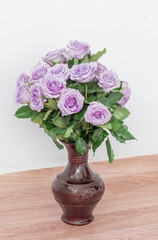 bouquet of beautiful purple roses with water drops in a vase