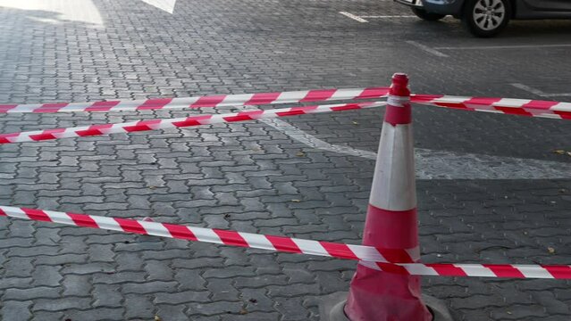 4K: Police red and white tape, do not cross blocking city street, demonstration, protest or crime scene