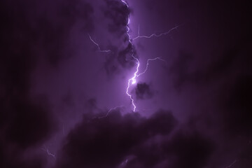 Lighning bolt over night sky in central europe. Huge lightning in a purple clouds at night. Night storm with lightnings. - Powered by Adobe