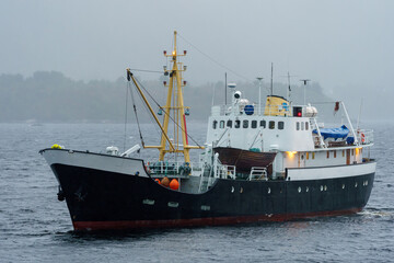 Fototapeta premium Old black and white steel ship at sea.