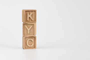 KYC know your customer guidelines in financial services theme. wooden cubes with the acronym KYC, on white background