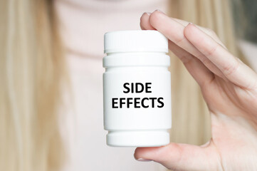 Side Effects - Medical doctor holds a white can of medicine