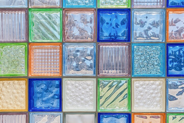 Glass colorful background from square blocks. Close-up, abstract background, construction of glass walls or partitions, modern interior decoration