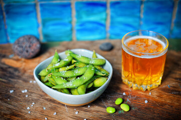 Boiled and salted edamame beans with fresh beer