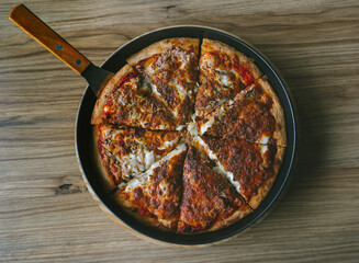 Delicious homemade pizza with tuna and green pepper. Tasty traditional fast food on wooden board table. Top view. Flat lay