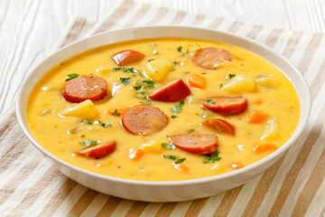 German potato soup with sausages in bowl