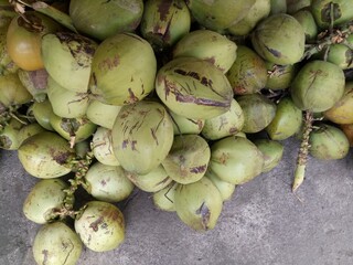 some green coconuts on the floor