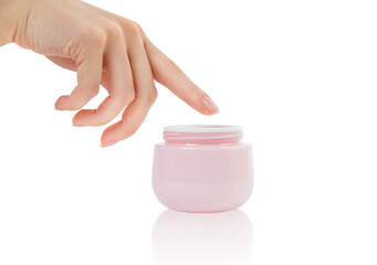 Female hand dipping finger into moisturizer cream.