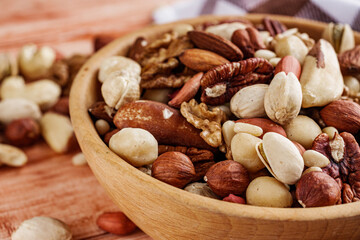 set of different nuts on a wooden rustic background