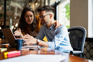 Fototapeta premium Colleagues in office. Businesswoman and businessman working on the project.