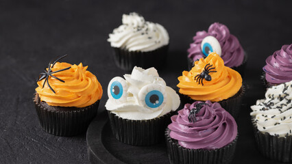 Halloween cupcakes with buttercream and holiday decoration. Halloween muffin. Halloween creative food.