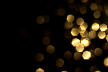 Golden blurred bokeh lights on black background. Glitter sparkle stars for celebrate. Overlay for...