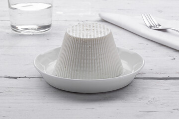 whole cottage cheese with pieces of cottage cheese on a white background