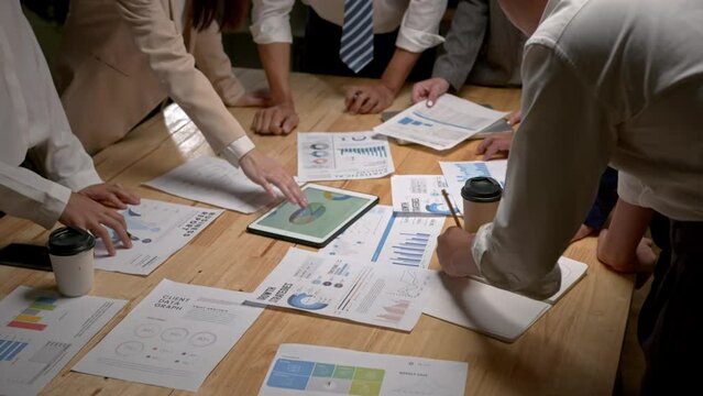 Group of Asia business people discussing business brainstorming meeting ideas strategy in night office. coworker and teamwork concept.