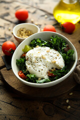 Healthy kale salad with fresh cheese and pine nuts