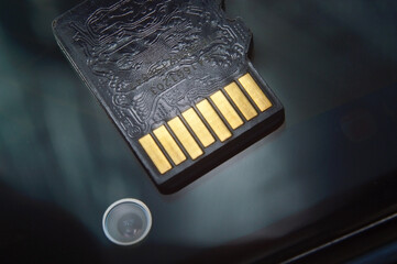 micro sd card lies on the smartphone screen. close-up