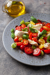 healthy colorful tomato mozzarella basil salad with balsamic vinegar dressing