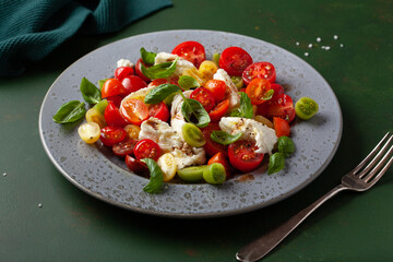 healthy colorful tomato mozzarella basil salad with balsamic vinegar dressing