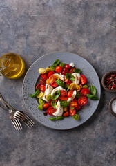 healthy colorful tomato mozzarella basil salad with balsamic vinegar dressing