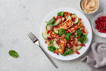 healthy halloumi cheese and couscous salad with cucumber spinach pomegranate hummus