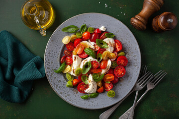 healthy colorful tomato mozzarella basil salad with balsamic vinegar dressing