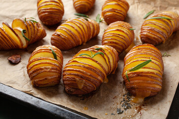 baked hasselback potato with cheddar cheese and rosemary