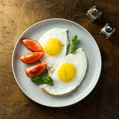 Roasted eggs with tomatoes and basil
