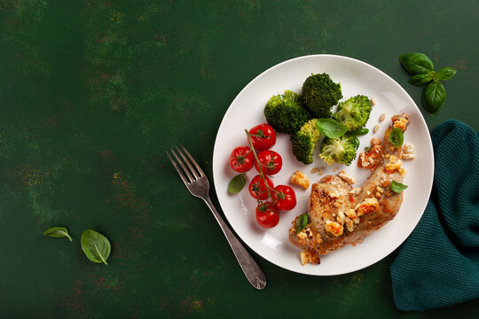 chicken legs backed with feta cheese tomatoes and broccoli, healthy keto meal