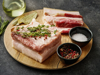 Korean Traditional BBQ Pork. Raw Pork belly. Fresh pork belly, salt, pepper and garlic on wooden board