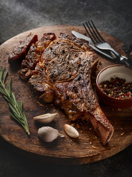 Barbecue Tomahawk Steak on Cutting Board. Steak on the bone. Succulent grilled tomahawk beef steak