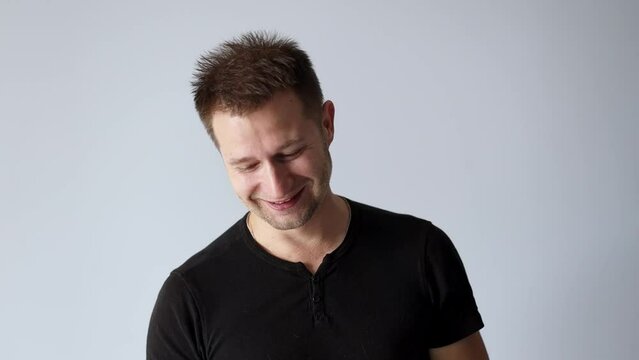 Handsome man in black t-shirt laughing out loud