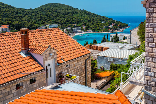 Top view of the sunlit red tiled roofs and Adriatic sea