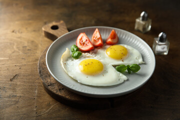 Roasted eggs with tomatoes and basil