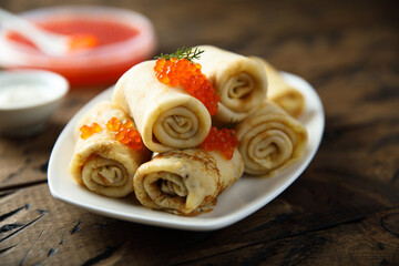 Traditional homemade crepes with red caviar