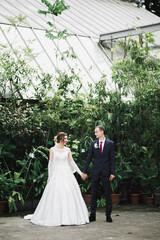 Fototapeta premium Wedding couple holding hands, groom and bride together on wedding day