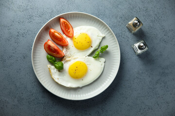 Roasted eggs with tomatoes and basil