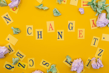Word from letters change on yellow background. Concept of change. Flat lay.